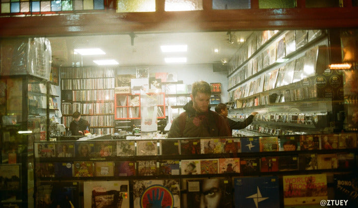 Kodak 200 photo of a man in a window in a record shop